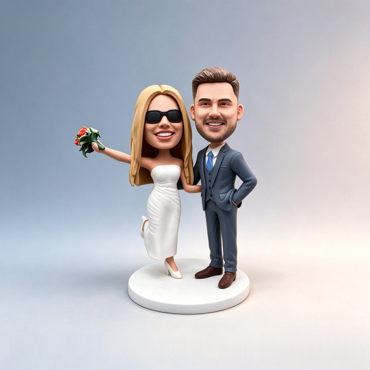 Front view of a custom wedding couple figurine handmade from a customer's wedding photo, standing on a white round base