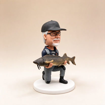Side view of a custom fisherman figurine holding a fish