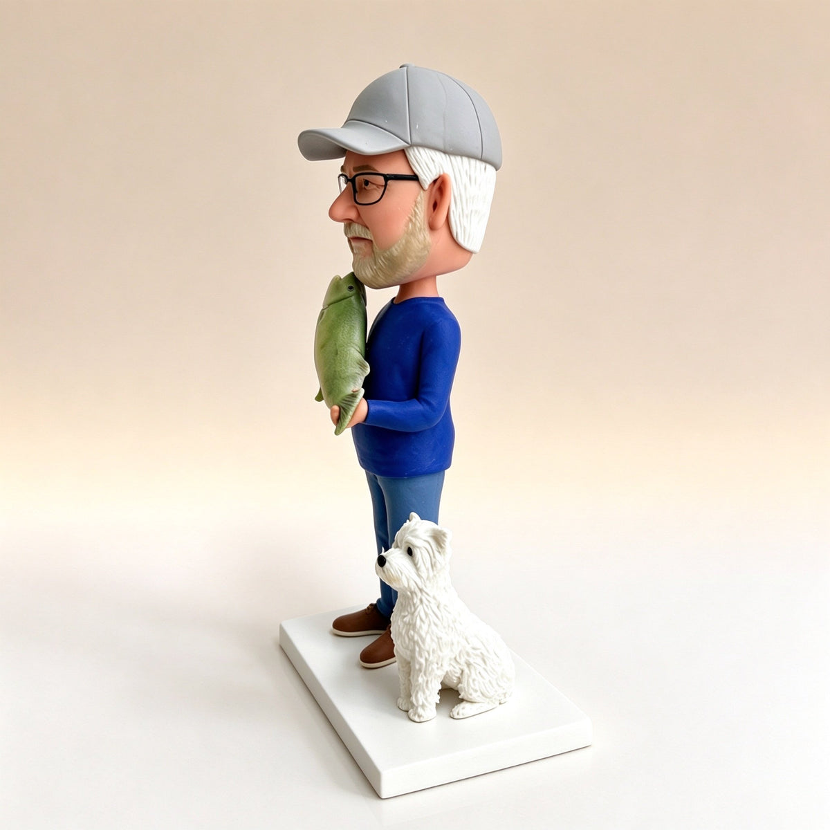 Side view of a custom fisherman figurine with his dog