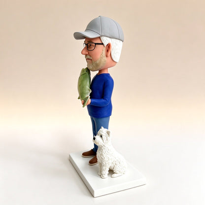 Side view of a custom fisherman figurine with his dog