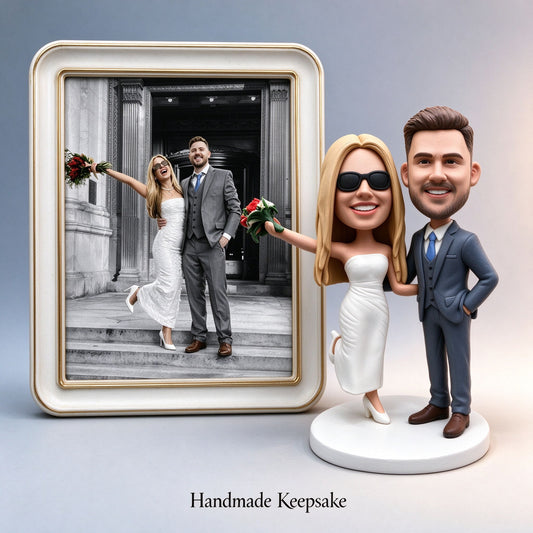 Custom wedding couple keepsake figurine displayed next to a framed photo of the real couple - handmade to order from your photo